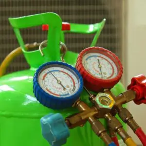 A green tank with two gauges on it.